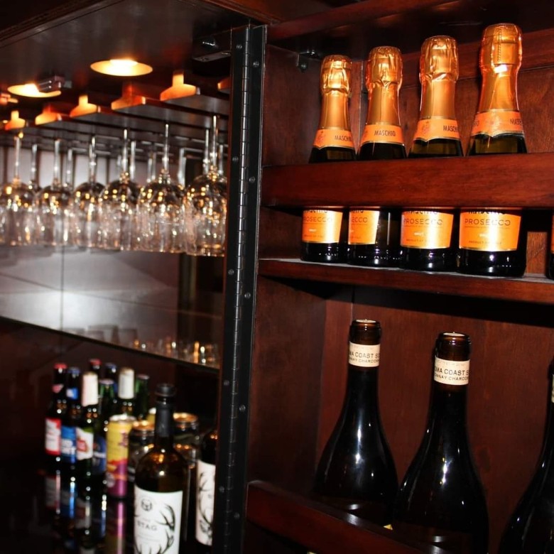 wines and glasses behind a bar