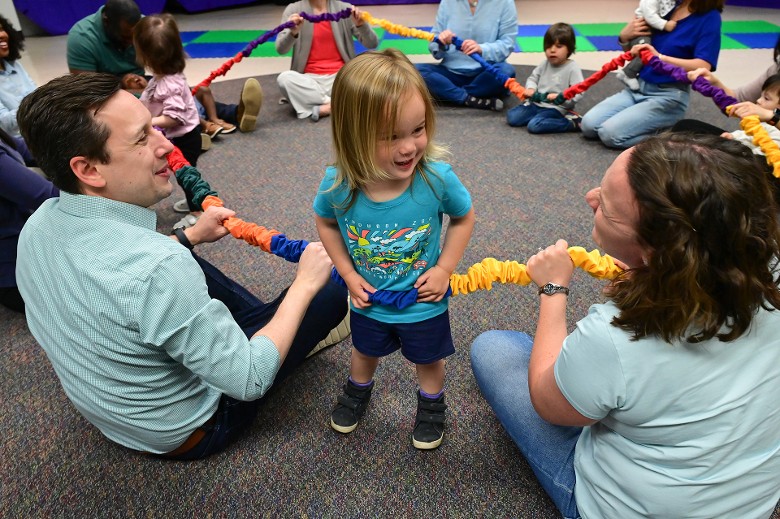 parents playing with a child