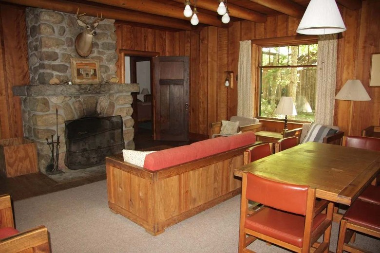 a living room with a stone fireplace