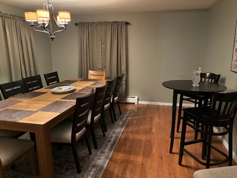 dining room with a table, chairs, and a high table and chairs