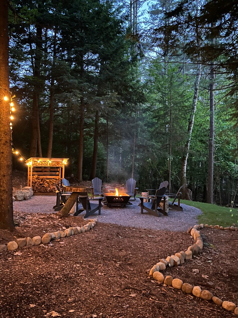 The outdoor firepit is steps away from the house and has everything you need to have a fire pit at the end of the day