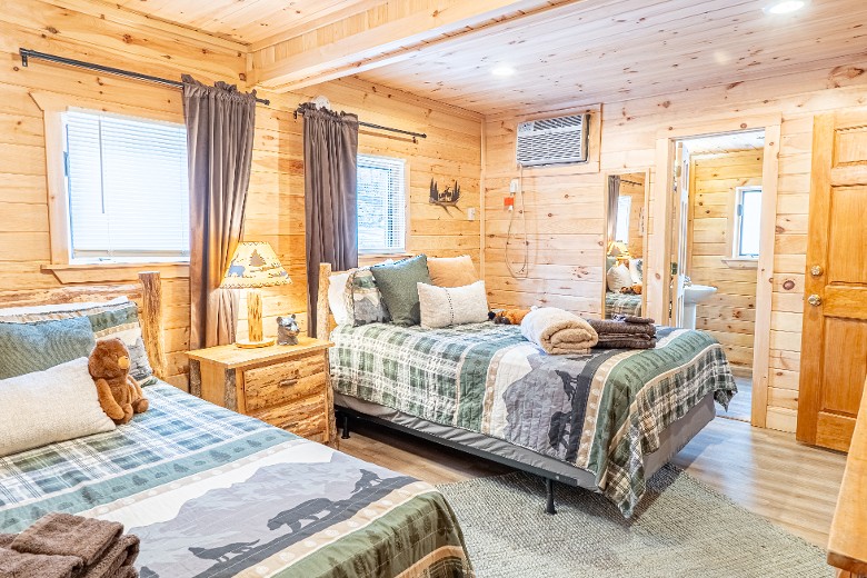 The first bedroom has two queen beds, complete with a TV for your entertainment.