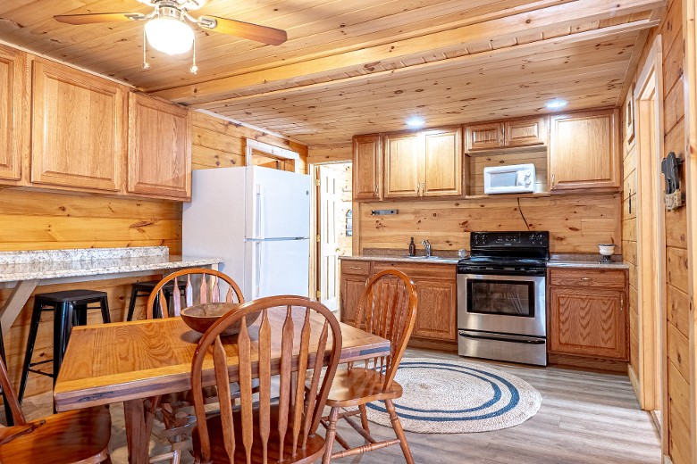 The main area includes a full kitchen with a dining table, making it easy to prepare meals or snacks during your stay.