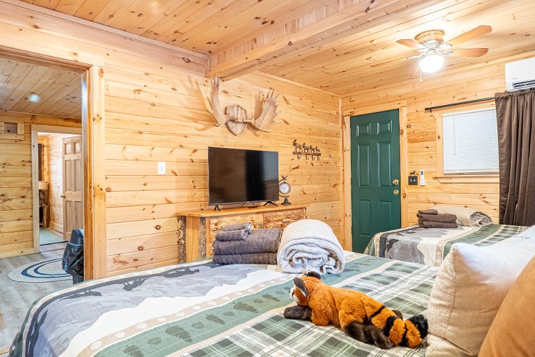 The first bedroom has two queen beds, complete with a TV for your entertainment.