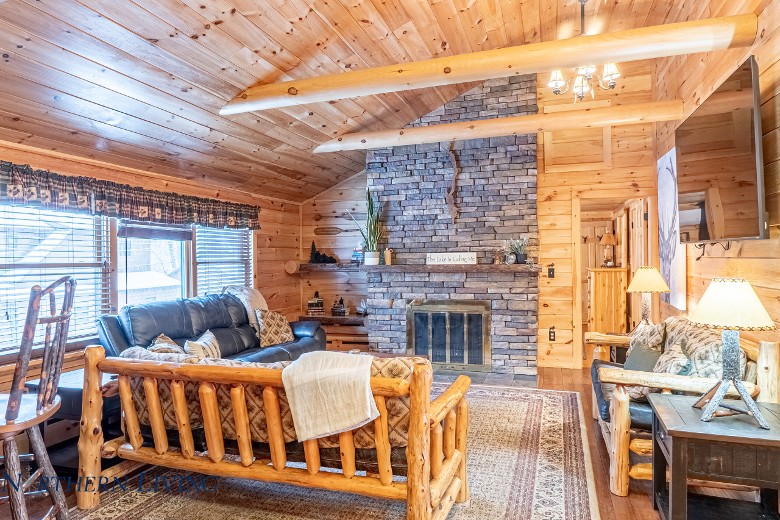 living room with stone fireplace