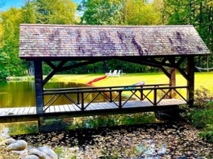 Welcoming foot bridge leading to the main home .