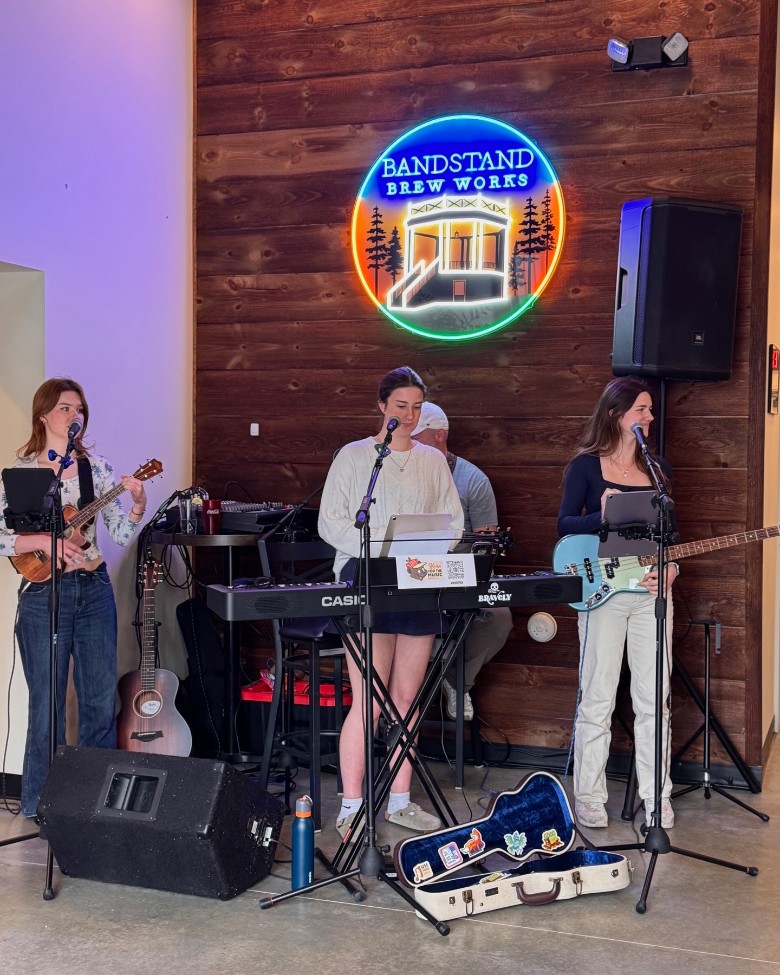 a small band playing in a brewery