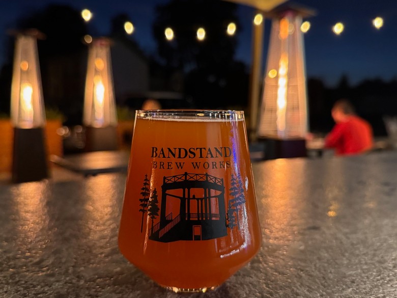 craft beer on a patio table at night