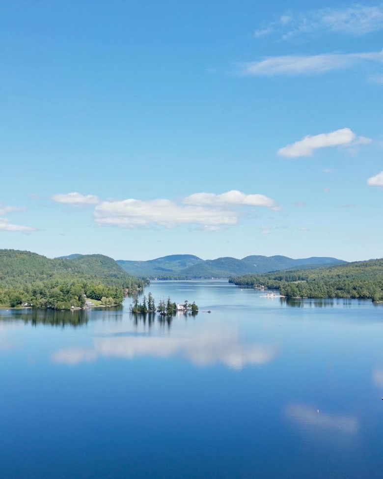 a calm lake with mountains in the distance