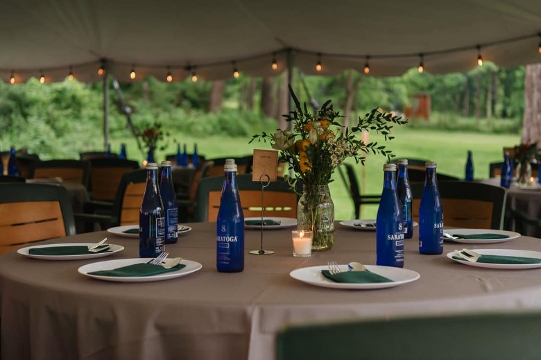 reception tables with saratoga water and plates