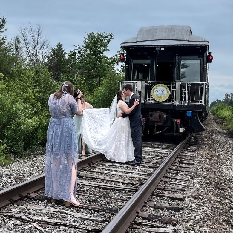 married couple photo by a train