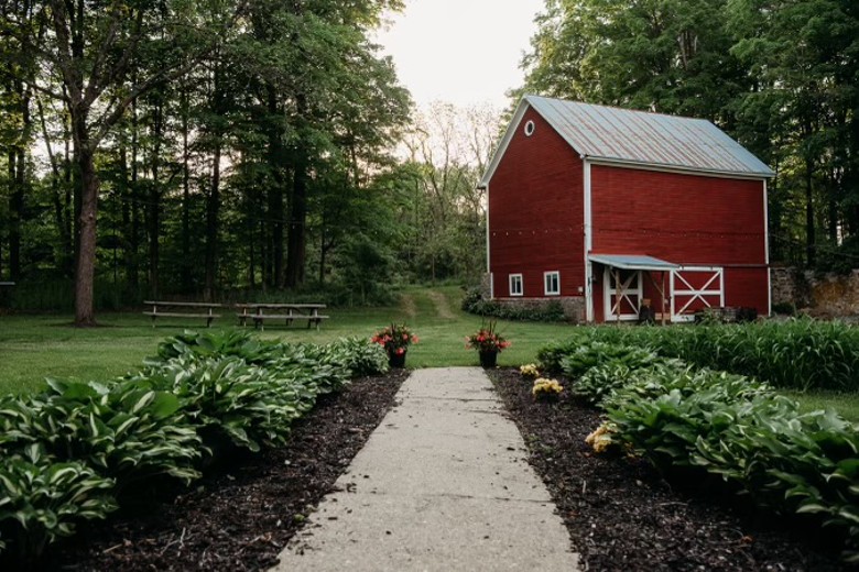 red barn in a wooded area