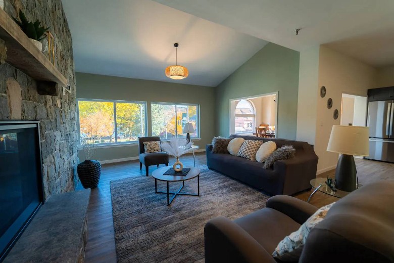 living room with fall foliage out the windows