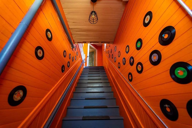 stairs with records on the wall on either side