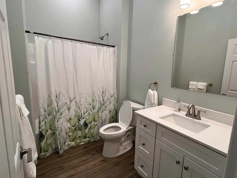 bathroom with sink, toilet, and shower