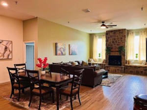 living and dining area with stone fireplace
