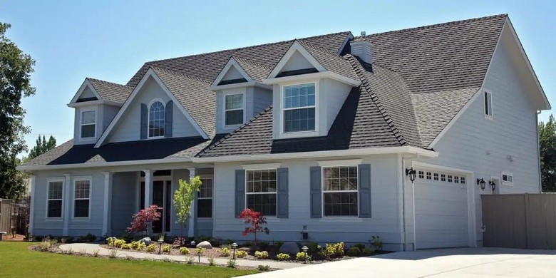 At TopGen Roofing, integrity is part of every project they take on. front of a large white house