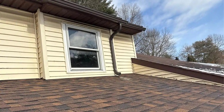 TopGen Roofing delivers craftsmanship you can see from every angle. brown roof with gutter