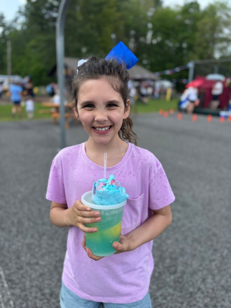 girl holding a drink outdoors