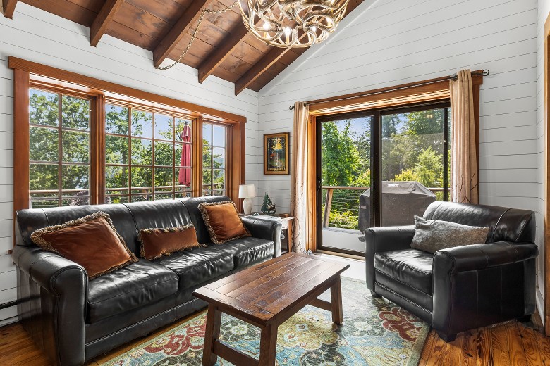 Main floor living room seating area. Patio door leads to the deck.