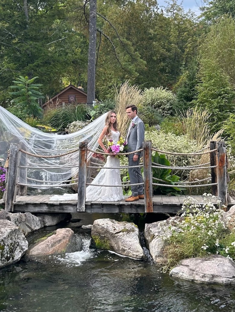 a couple standing on a small bridge