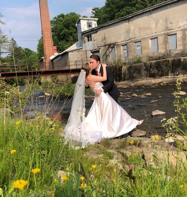 bride and groom kissing outdoors