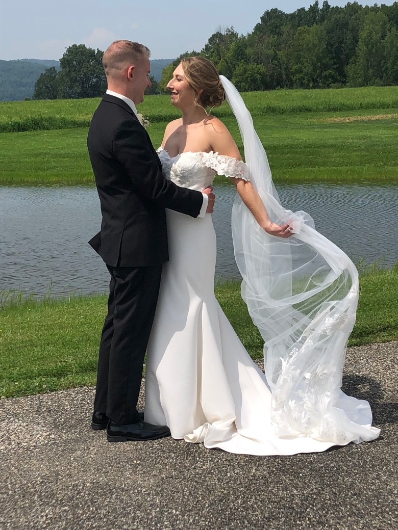 bride and groom embracing at golf course