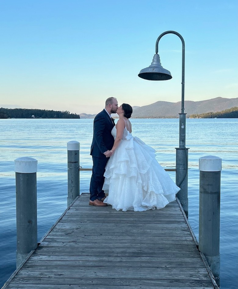bride and groom on a lake dock