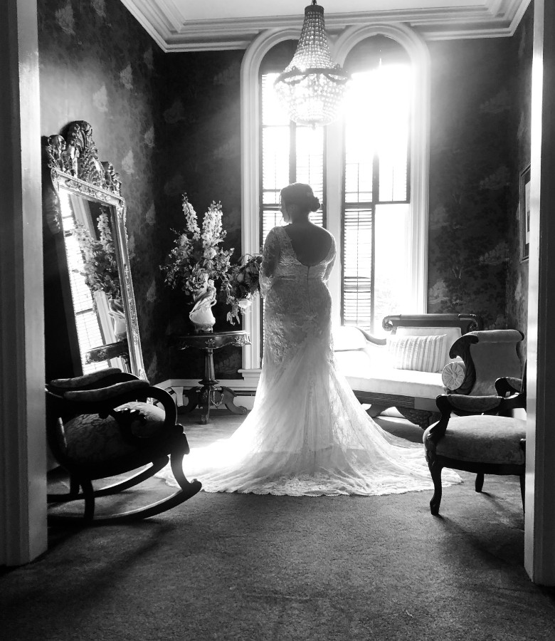 black and white photo of bride getting ready for wedding