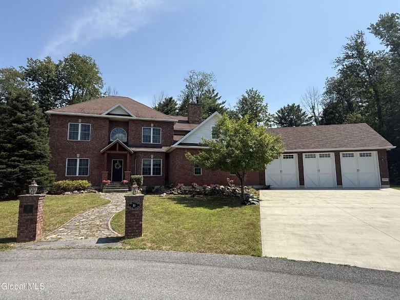 brick home with three garage doors
