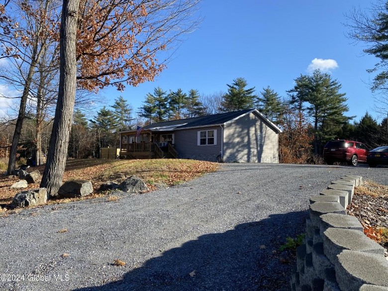 gravel driveway leading up to a home