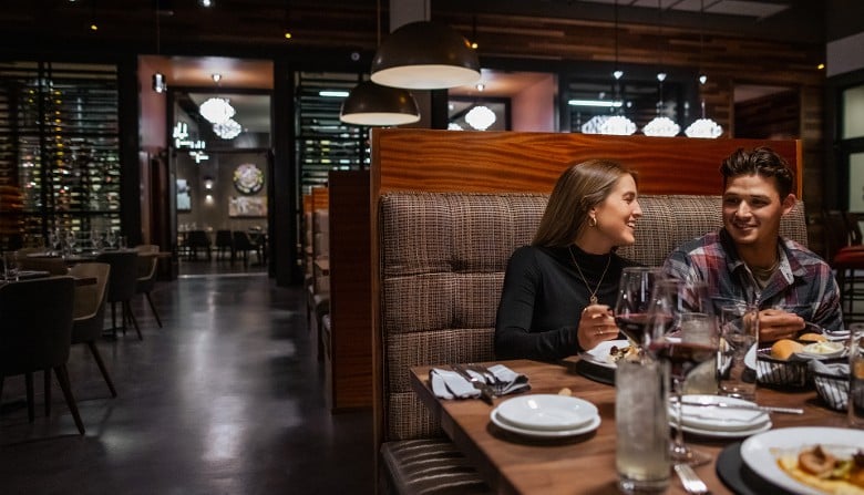 man and woman seated at a restaurant table