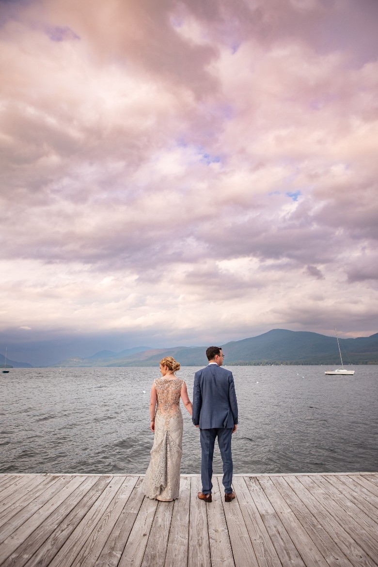 bride and groom facing the lake
