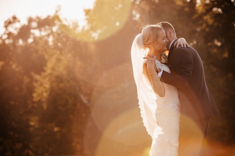bride and groom embracing outdoors