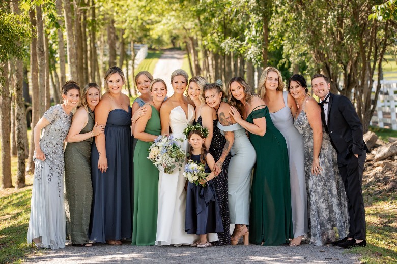 photo of the wedding party with woods in background