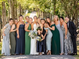 photo of the wedding party with woods in background
