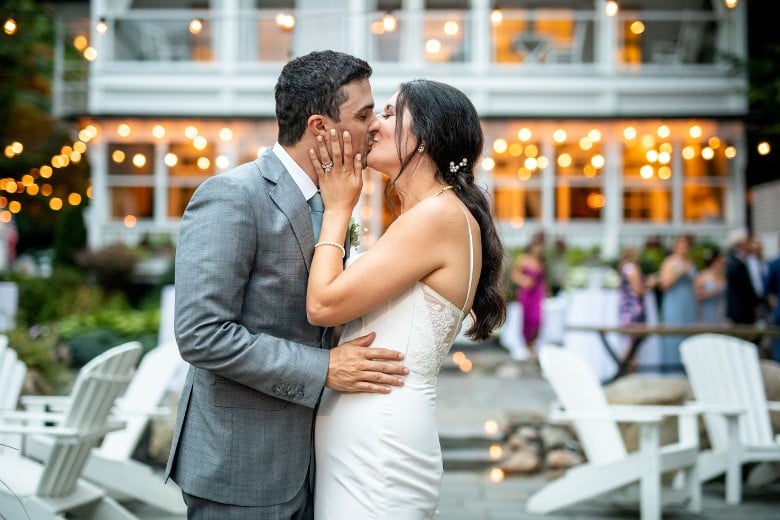 bride and groom kissing at outdoor venue