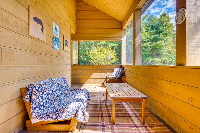 enclosed porch with table and seating