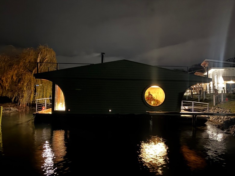 outside of a floating sauna at night