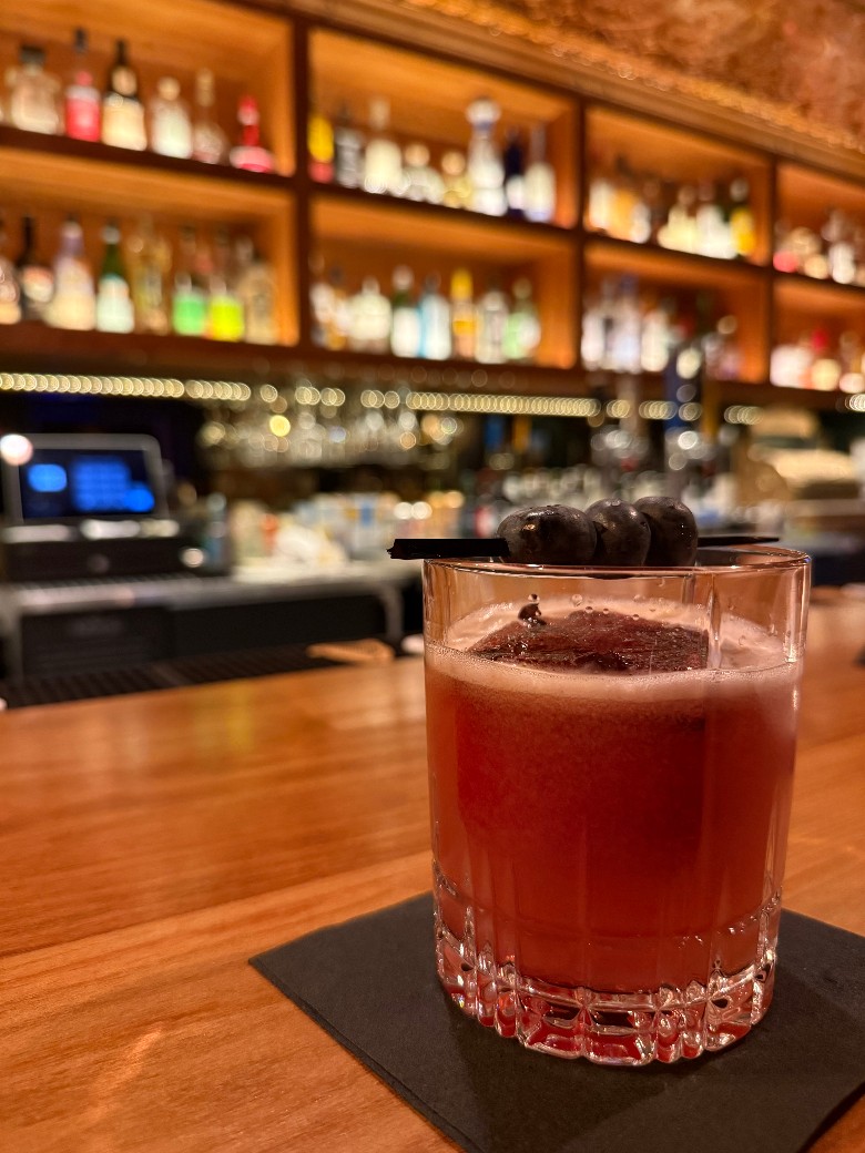 a cocktail on a black napkin