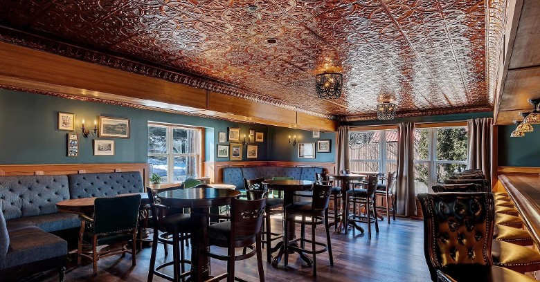 an upscale bar with both bar and table seating