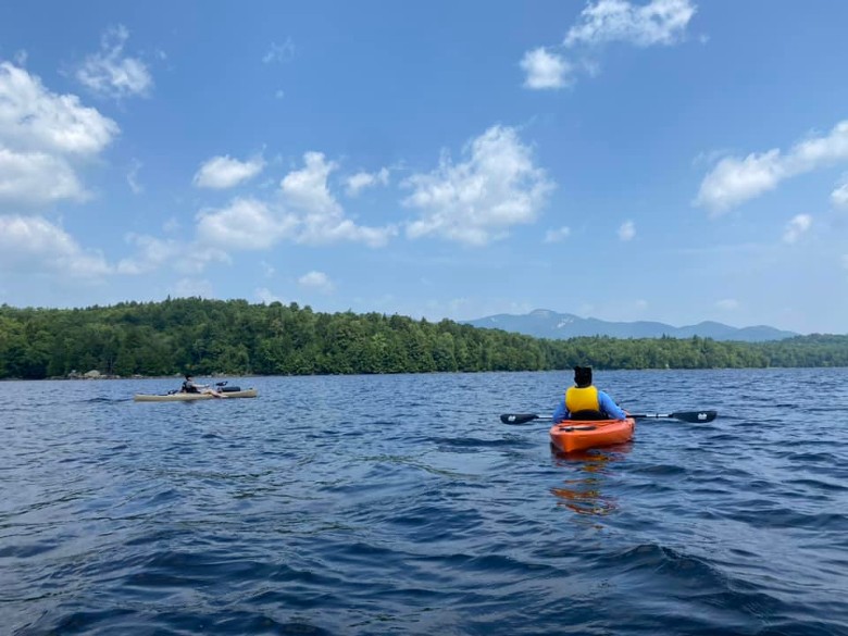 two people kayaking on a lake