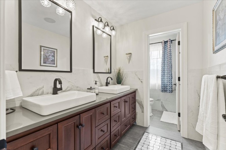 Second level full bathroom with double sinks and a shower.