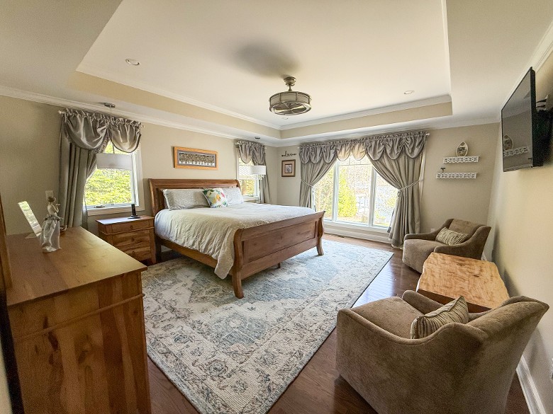 Master bedroom with king bed and lake views.