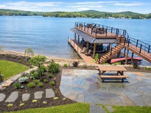 a two story deck on a lake