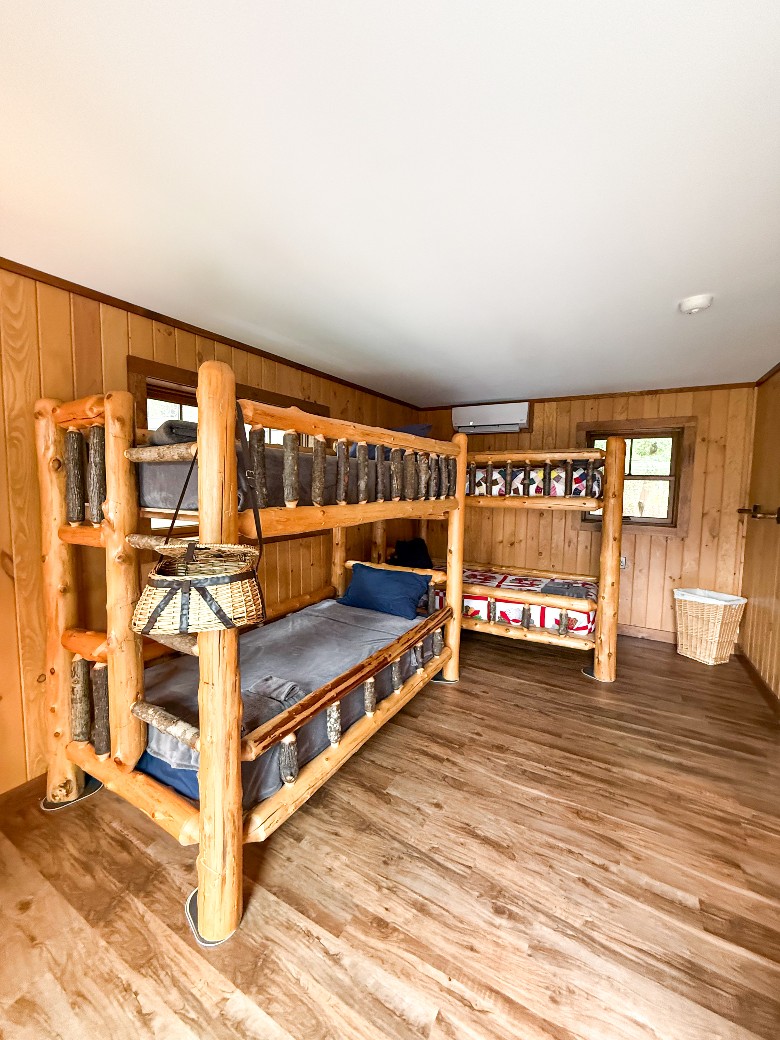 This waterfront Lake George vacation property also includes a charming guest house, complete with a kitchenette, queen bed, two twin-over-twin bunk beds, and a full bathroom&mdash;ideal for extended family or added privacy.