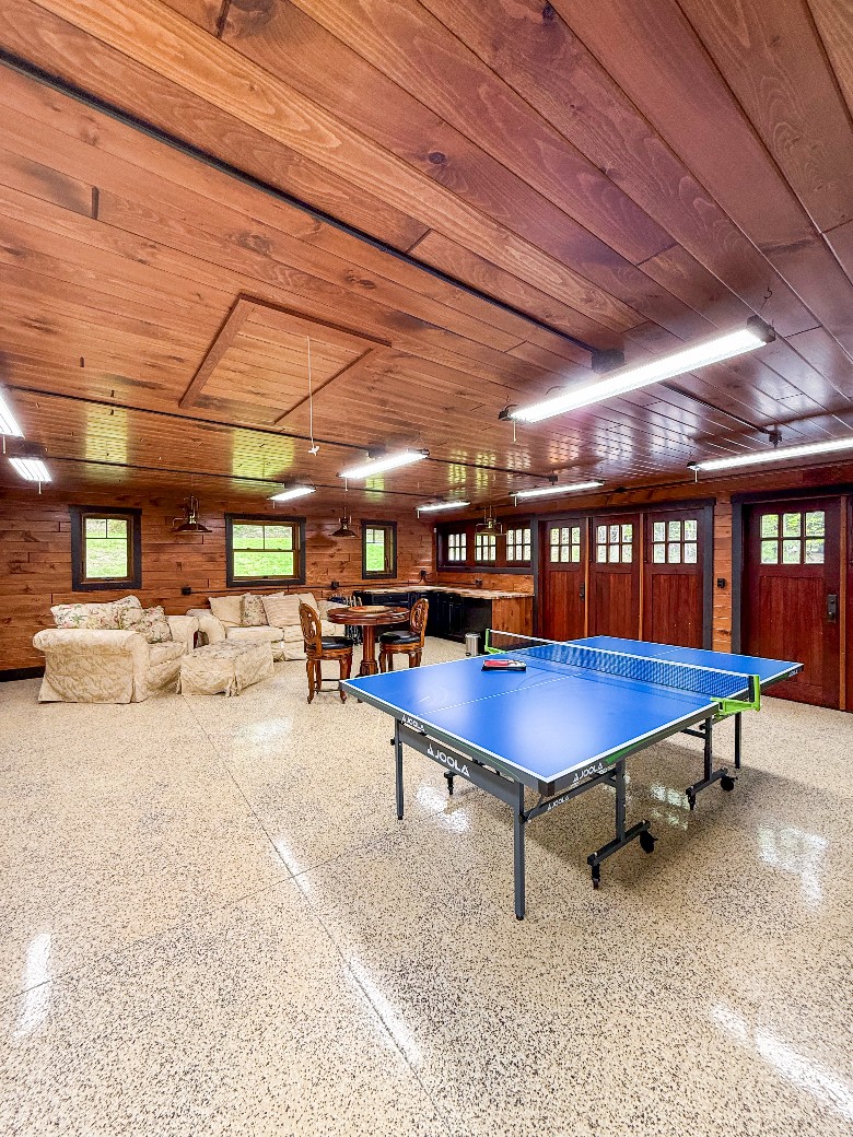 Attached to the guest house is a large game room with a ping pong table and additional laundry space.