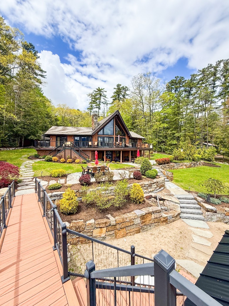 ​exterior of a large home on the lake from top of boathouse