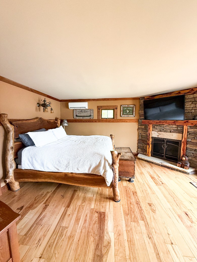 The master bedroom offers a luxurious king bed, a gas fireplace, and an ensuite bathroom.