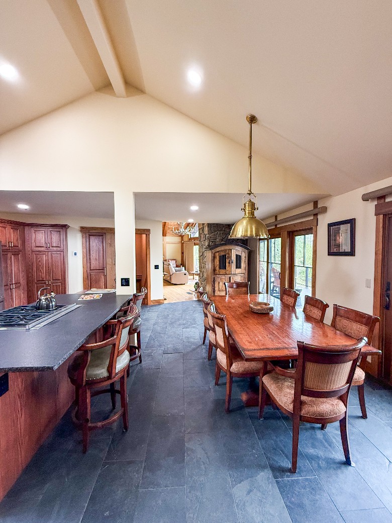 At the heart of this lakefront vacation home rental on Lake George is a stunning open-concept kitchen, dining, and living area, thoughtfully designed for both entertaining and relaxation.